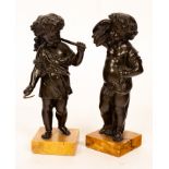 A pair of bronze putto, the harvesters, both raised on variegated marble bases,