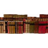 A quantity of faux book leather spines most with titles and volume numbers,