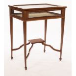 An Edwardian vitrine table, the hinged glazed top,