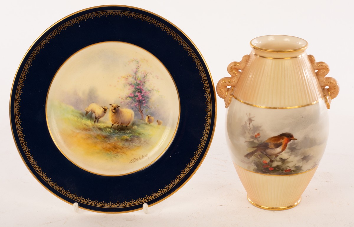 A Royal Worcester vase painted a robin in holly by H Stinton, the fluted body with serpent handle,