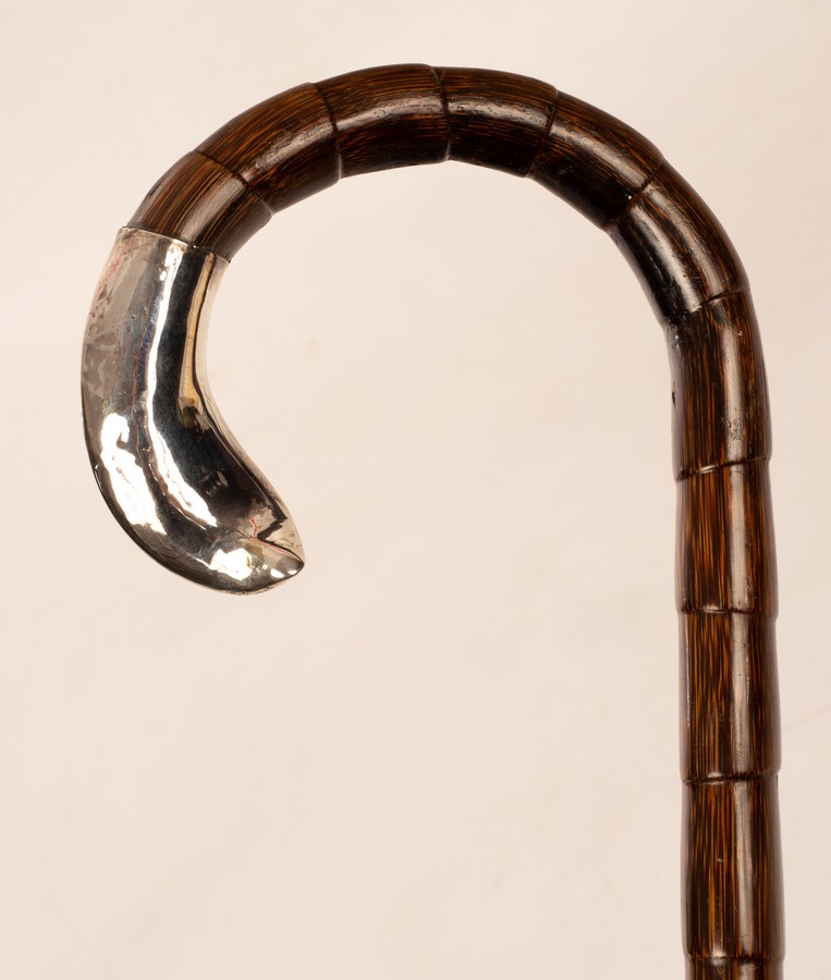 A gentleman's walking cane with silver mount,