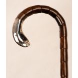 A gentleman's walking cane with silver mount,