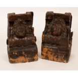 A pair of 17th Century architectural oak corbels carved as the heads of a gentleman and a lady,