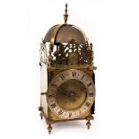 An English lantern clock with pin and hoop support,