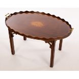 A tray top coffee table, the oval top with a galleried border,