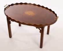 A tray top coffee table, the oval top with a galleried border,