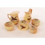 Four Royal Worcester miniature lidded boxes of circular form painted birds in flight, 5.