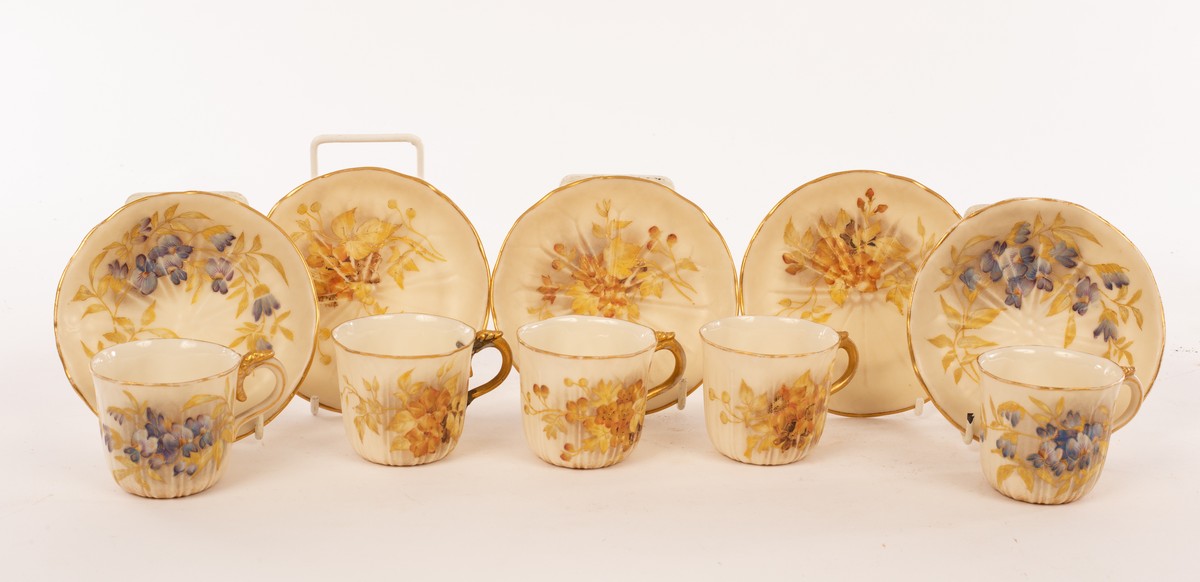 Five Royal Worcester cups and saucers of ribbed form with gilt borders painted sprays of violets