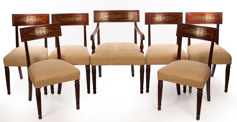 Six Regency mahogany dining chairs, the cresting rails inlaid brass scrolls etc.
