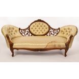 A Victorian two-chair back sofa, deep buttoned with oval back and pierced scroll surround,