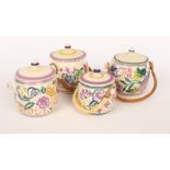 Poole Pottery, four floral biscuit barrels, three with raffia handles, the largest 15.