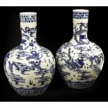 A pair of 20th Century Chinese globular blue and white vases with slender necks,