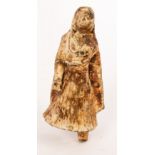 An early Indian terracotta figure of a veiled woman wearing a pleated dress,