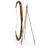 An Indian archers' bow koman, 74cm long and three feather tipped arrows with polychrome highlights,