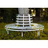 A wrought iron circular slatted tree seat,