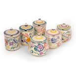 Poole Pottery, three floral jam pots and covers,