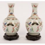 A pair of late 19th Century Chinese pear-shaped vases painted butterflies,