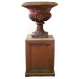 A terracotta campana-shaped vase on a pedestal base,