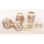 Poole Pottery, two floral biscuit barrels with raffia handles, both with printed marks,