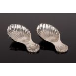 A pair of silver shell pattern caddy spoons, S J Rose & Son, Birmingham 1964, with shell bowls,
