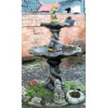 A two-tier fountain with putto finial and entwined dolphin supports,
