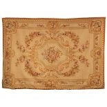 An Aubusson style tapestry, the central bouquet and garland surround within a floral border,