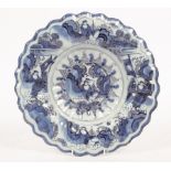 An 18th Century blue and white Delft dish with reeded serrated border,