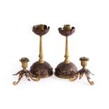 Style of WAS Benson, a pair of Arts & Crafts brass short candlesticks,