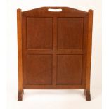 An Arts & Crafts oak firescreen, possibly Gordon Russell, with pierced handle to top, 55cm wide, 69.