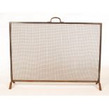 An Arts & Crafts steel fire screen, the frame decorated with gadrooned border and handle to top,