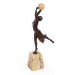 An Art Deco style spelter figure of a dancer holding a resin ball, on an onyx type base, 35.