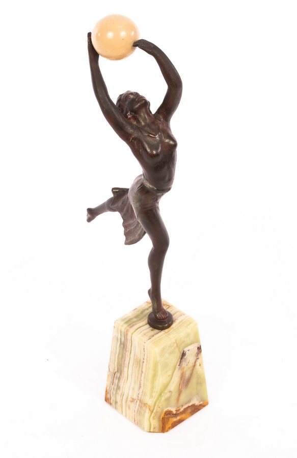 An Art Deco style spelter figure of a dancer holding a resin ball, on an onyx type base, 35. - Image 3 of 4