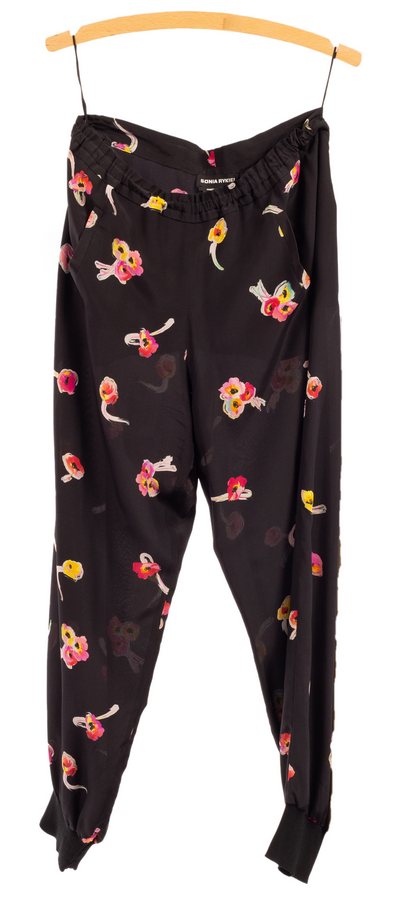 A pair of Sonia Rykiel silk trousers, polychrome sprays of flowers on a black ground,