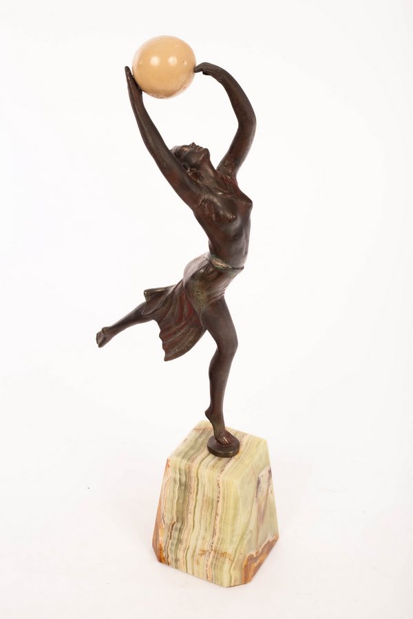 An Art Deco style spelter figure of a dancer holding a resin ball, on an onyx type base, 35. - Image 4 of 4