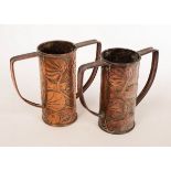 A near pair of Arts & Crafts copper twin-handled vases, embossed stylised fish and water lilies, 20.