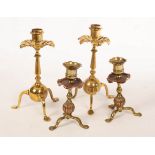 Style of WAS Benson, a pair of copper and brass tripod candlesticks,