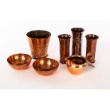 Keswick School of Industrial Arts, a group of copper ware, comprising: a pair of cylindrical vases,