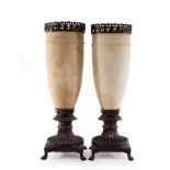 A pair of Art Deco style alabaster lamps with bronze mounts and square stands with claw feet,