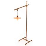 A copper standard floor lamp with adjustable arm,