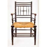 A Liberty Argyll armchair, circa 1880, with ebonised frame and rush seat,