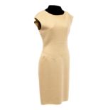 A Chanel boiled wool cream fitted sleeveless dress, lined, with Chanel label to pocket,