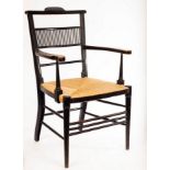 An Aesthetic movement ebonised armchair, in the manner of E W Godwin,