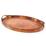 A Newlyn copper tray embossed a border of fish and shells,