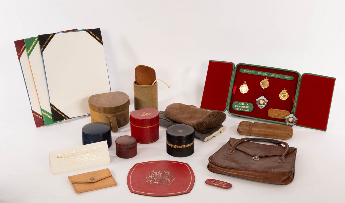 Theo Merrett, a group of hand tooled leatherwork, including handbag, boxes, purses and bookends,