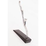 Hagenauer, a silvered metal stylised figure of a leaping gazelle, on dark wood base, stamped marks,