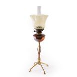 WAS Benson, a copper and brass oil lamp with leaf decoration, on four feet,