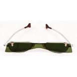 A pair of retro vintage sunglasses, 1960s, with flip-up green lenses (one cracked),