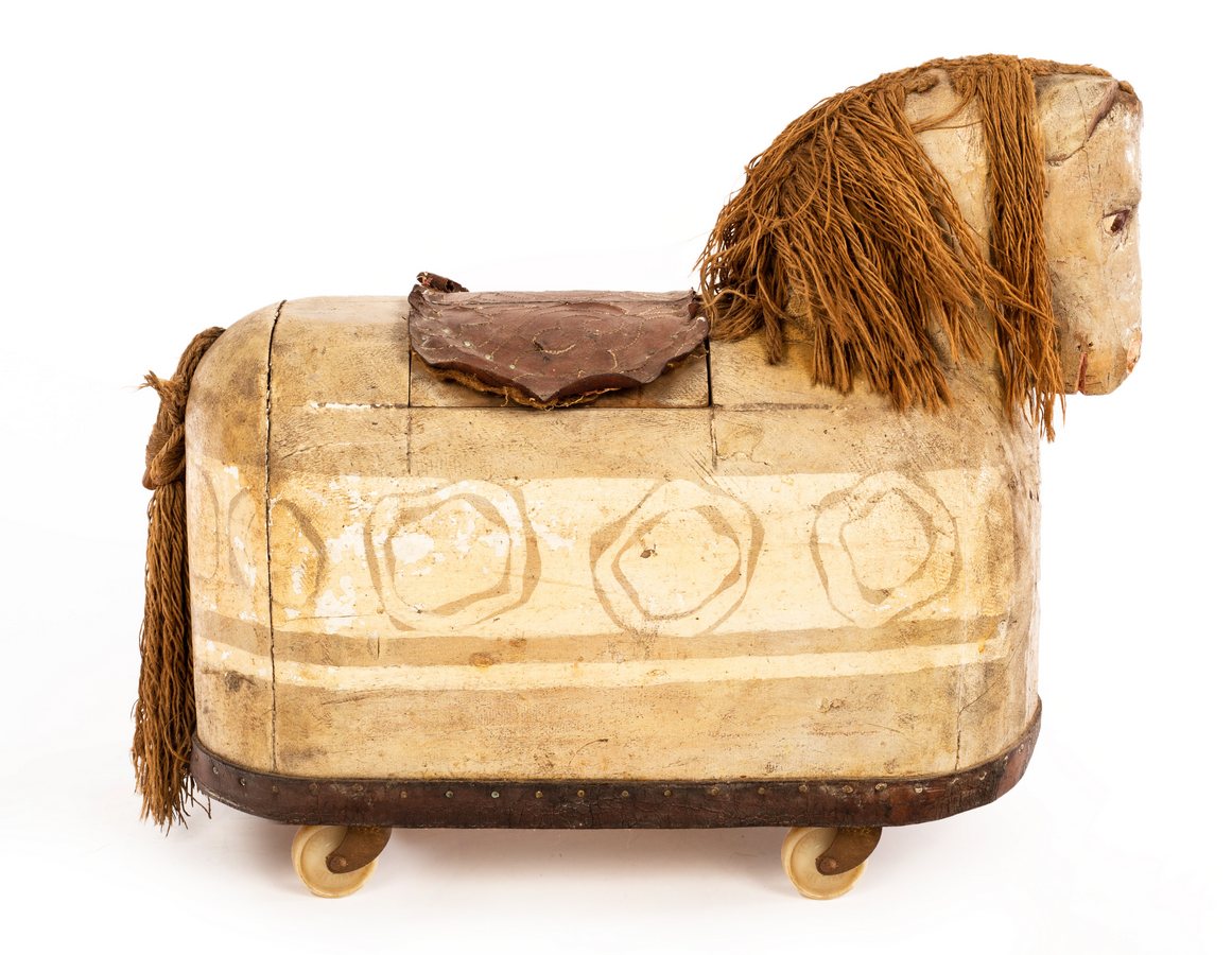 A 20th Century ride-on toy horse, possibly Scandinavian, with carved head and painted sides,