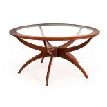 Victor Wilkins for G-Plan, a 1960s Spider coffee table, circular glass panel top on splay supports,