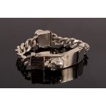 A 20th Century silver chain bracelet with two skulls,